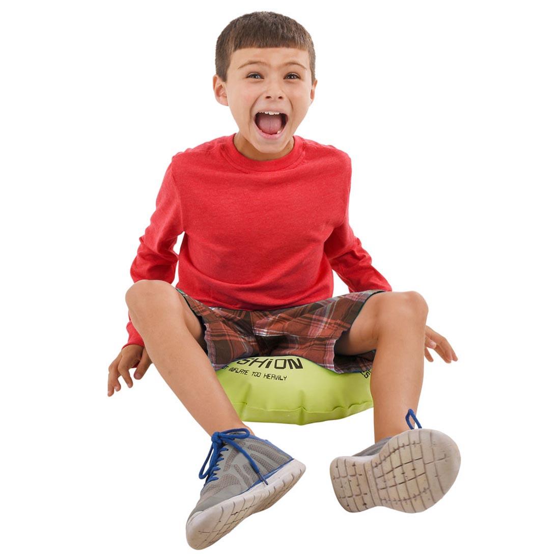 child sitting on the Mega Whoopee Cushion