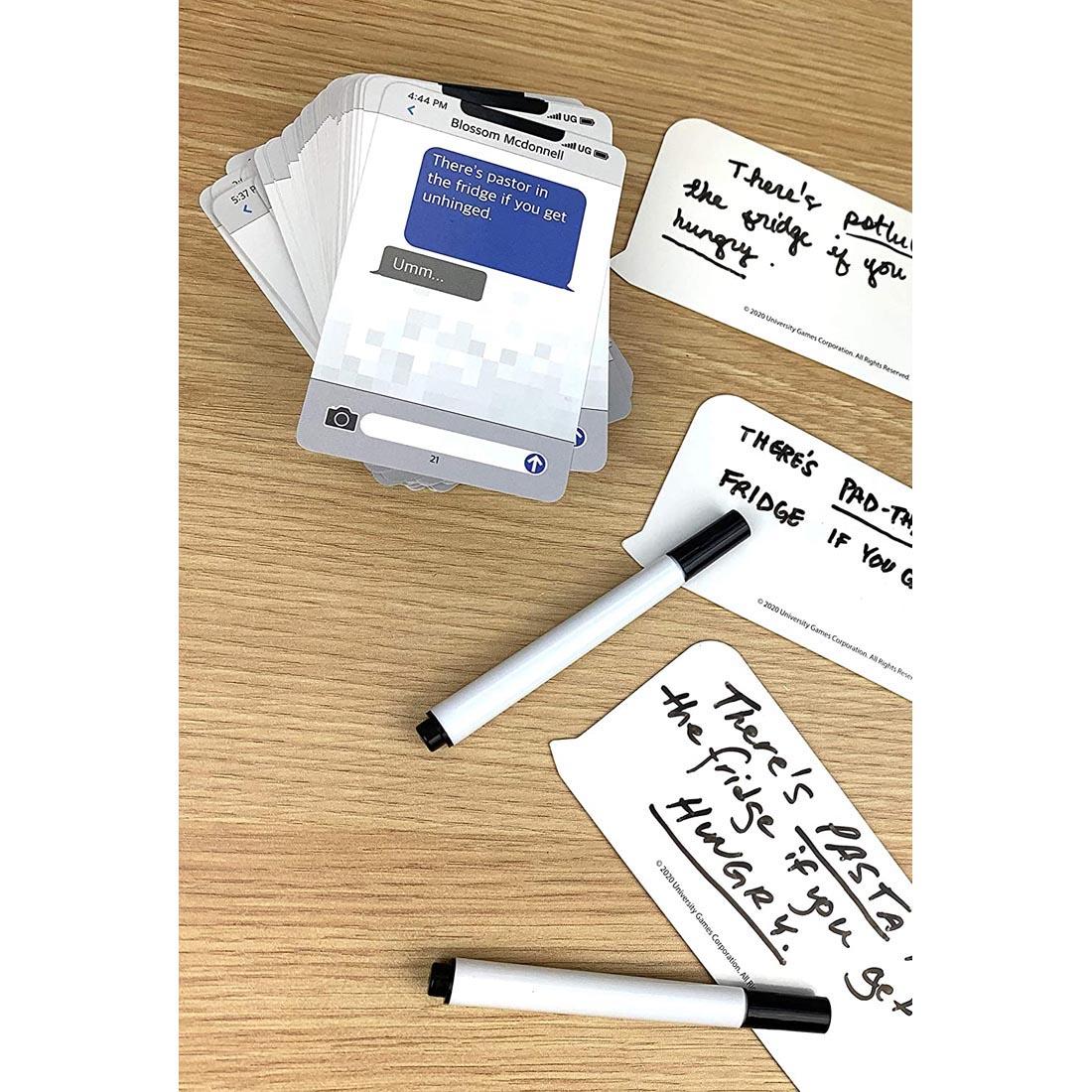 Cards from Autocorrect Card Game shown with sample handwritten answers