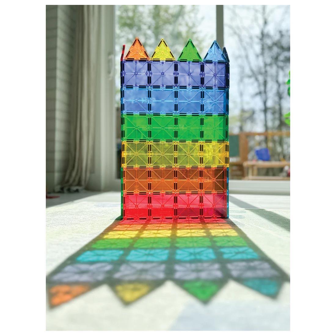 castle wall built with Magna-Tiles Clear Colors 100-Count Set; with sun shining through like a stained glass window