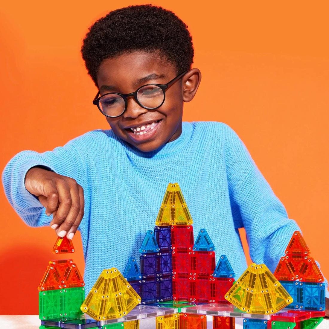 child playing with Magna-Tiles microMAGS Clear Colors