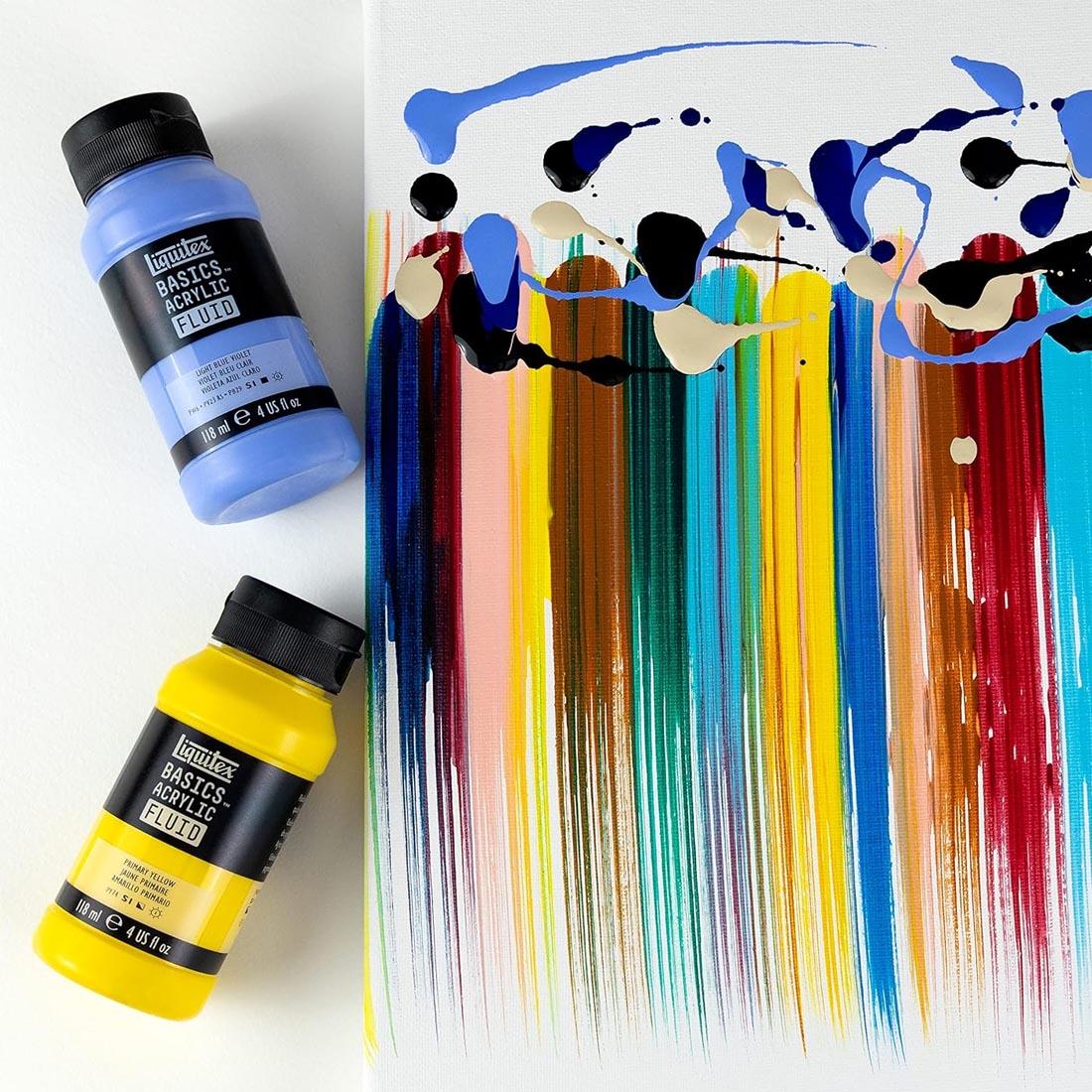two bottles beside a painting sample done with Liquitex Basics Acrylic Fluid 12-Color Set